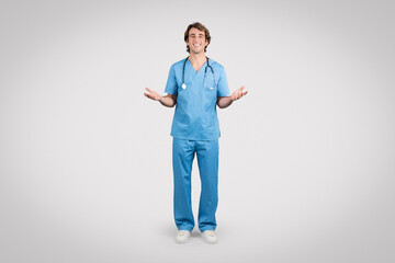 Inviting man nurse in blue scrubs with open hands
