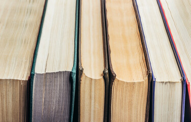 Photo of old antique books row, close up angle view.