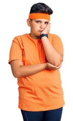 Little boy kid wearing sportswear thinking looking tired and bored with depression problems with crossed arms.