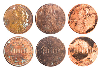 Isolated photo of old rusty worn american 1 cent coins on white background.