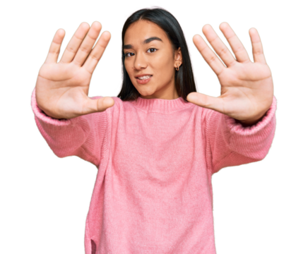 Young asian woman wearing casual winter sweater doing frame using hands palms and fingers, camera perspective - Powered by Adobe