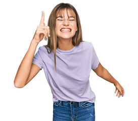 Fototapeta na wymiar Teenager caucasian girl wearing casual clothes pointing finger up with successful idea. exited and happy. number one.