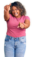 Young african american plus size woman wearing casual clothes pointing to you and the camera with fingers, smiling positive and cheerful
