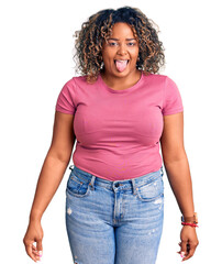 Young african american plus size woman wearing casual clothes sticking tongue out happy with funny expression. emotion concept.