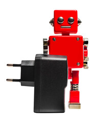 Isolated photo of red toy robot holding dc charger on white background.