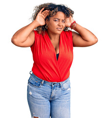 Young african american plus size woman wearing casual style with sleeveless shirt trying to hear both hands on ear gesture, curious for gossip. hearing problem, deaf