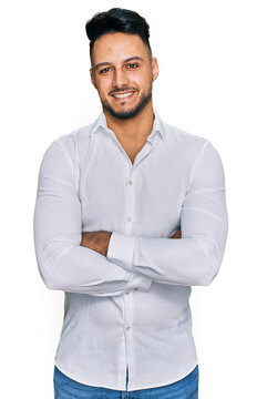 Young arab man wearing casual clothes happy face smiling with crossed arms looking at the camera. positive person.