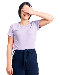 Obraz premium Brunette teenager girl wearing casual clothes smiling and laughing with hand on face covering eyes for surprise. blind concept.