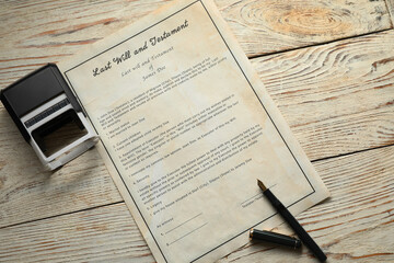 Last Will and Testament with stamp and pen on white wooden table, top view