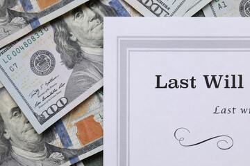 Last Will and Testament with dollar bills, top view