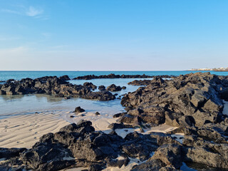 Fototapeta na wymiar This is a Jeju seascape with basalt rocks.