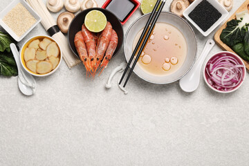 Cooking delicious ramen soup. Different ingredients on beige table, flat lay. Space for text - obrazy, fototapety, plakaty