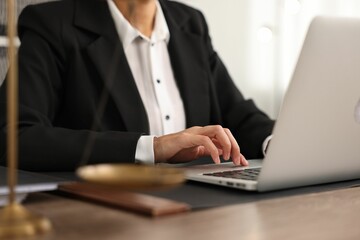 Notary using laptop at workplace in office, closeup