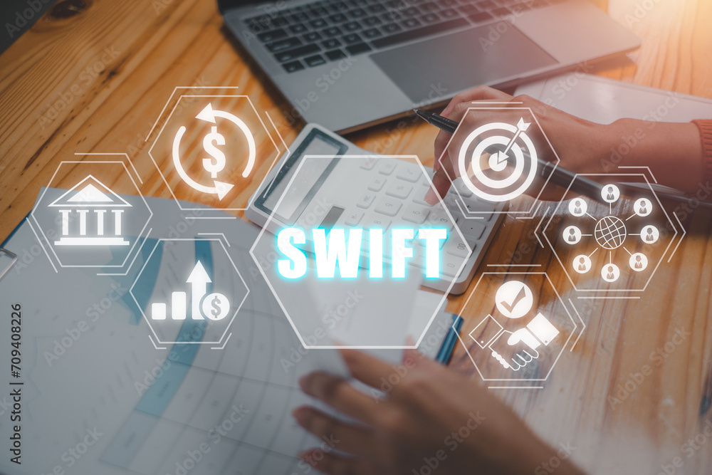 Poster swift concept, business woman using calculator on office desk with swift icon on virtual screen.