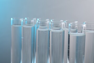 Laboratory analysis. Test tubes with liquid samples on color background, closeup