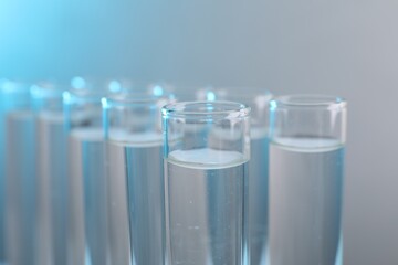 Laboratory analysis. Test tubes with liquid samples on color background, closeup
