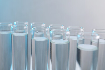 Laboratory analysis. Test tubes with liquid samples on color background, closeup