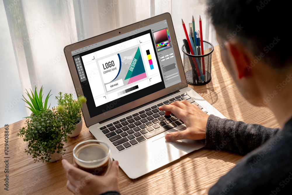 Poster graphic designer software for modern design of web page and commercial ads showing on the computer s