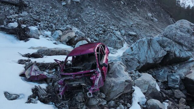 Broken car amidst snowy mountains aerial around view contrast of nature and wreckage. Broken car reminder of automotive accidents impact Broken car juxtaposing natural beauty with human error.