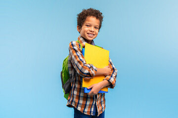 Smart student with folders and backpack, blue background