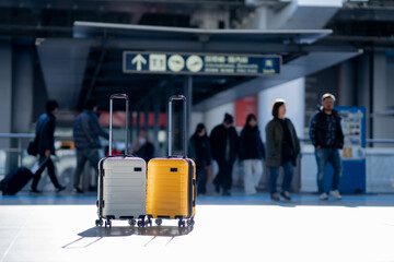 Two suitcases in an empty airport hall, traveler cases in the departure airport terminal waiting for the area, vacation concept, blank space for text message or design