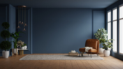 Modern interior of living room with leather armchair on wood flooring and dark blue wall
