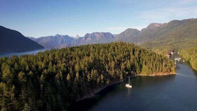 Sailboat anchored in mountain bay in Desolation Sound, Canada