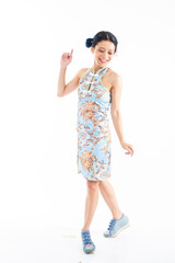 Portrait of an attractive Asian Chinese female wearing cheongsam or qipao isolated on white background for Chinese New Year concept