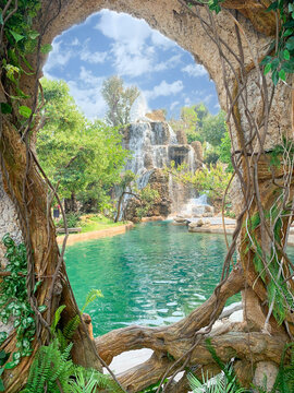 Closeup view of a beautiful waterfall and bright blue sky with clouds through holes in trees and then vines.
