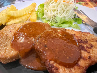 Closeup and crop Pork Steak with French Fries and Salad