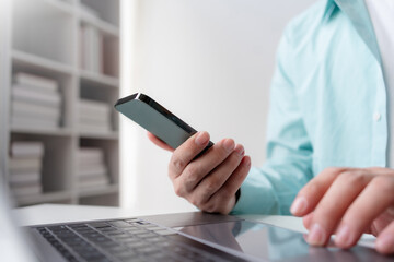 Close up of hands man hand using smartphone typing, chatting conversation in chat box. Man hands using smartphone in office, messaging or browsing social networks.