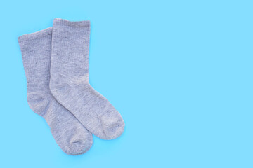 Grey socks on blue background.