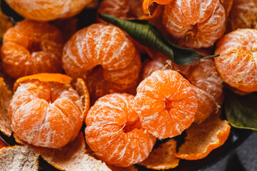 Tangerines with peeled skin on a plate