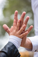 Little kid holding family member mother hand as a together family