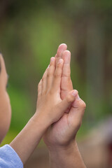 Little kid holding family member mother hand as a together family