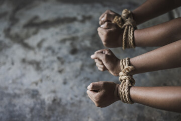 Victim boy with hands tied up with rope in emotional stress and pain, Stop violence against children and trafficking Concept.