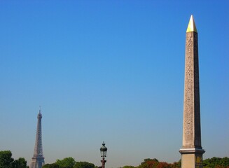 Luxor Obelisk at place de la concorde and Eiffel Tower under the blue sky in summer in Paris, France