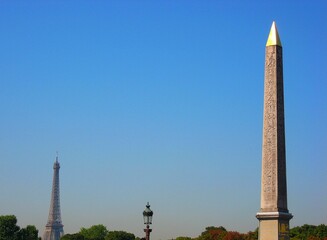 Luxor Obelisk at place de la concorde and Eiffel Tower under the blue sky in summer in Paris, France