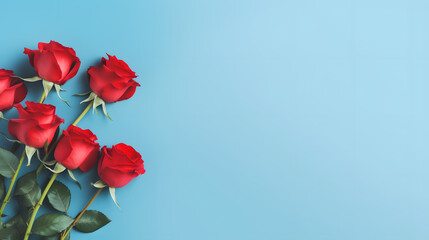 Obraz premium Red roses mock up banner on soft blue desktop background, top view. Layout for Valentines day, dating and love greeting card, anniversary and invitations. Retro styled, Bright color