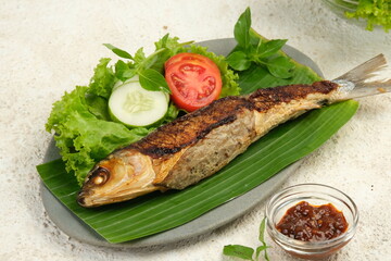 Bandeng Presto , Milkfish Cooked with Pressure Cooker, Served with Chilli Paste (Sambal) and Fresh Vegetable.	