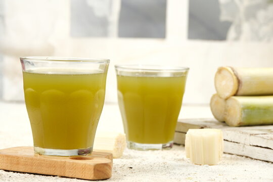 glass of fresh iced sugar cane drink or es tebu on white background	