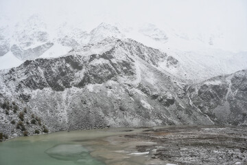 High peaks of Donguzorun mountain ridge with lake