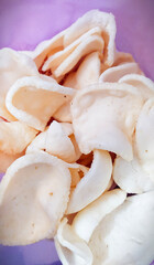 close up of shrimp crackers in a plastic container