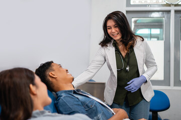 beautiful Asian woman doctor advising blood transfusion patient lying in hospital room