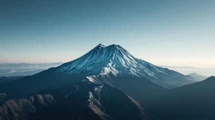 Fototapeta premium Aerial view of a lone, snow-capped mountain peak