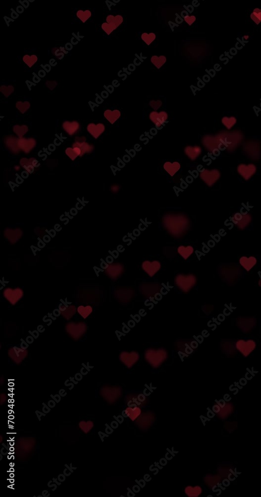 Poster seamless loop flickering hearts falling down on black vertical background.