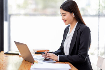 Asian businessman hand using calculator and working with laptop calculate about finance accounting at workplace.finance accounting concept