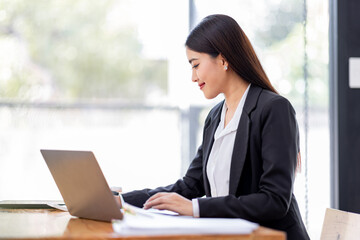 Asian businessman hand using calculator and working with laptop calculate about finance accounting at workplace.finance accounting concept