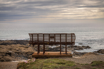 Fototapeta na wymiar An old rusty bench in Treyarnon Bay, Cornwall, England, UK