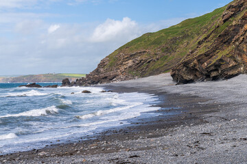Fototapeta na wymiar The cliffs and beach in Millook Haven, Cornwall, England, UK